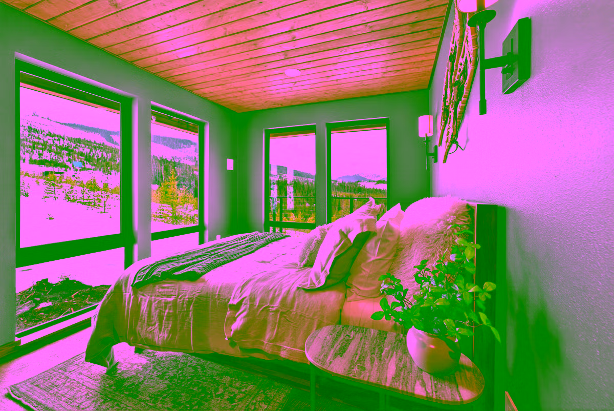Main bedroom with snow-covered mountains visible through the window