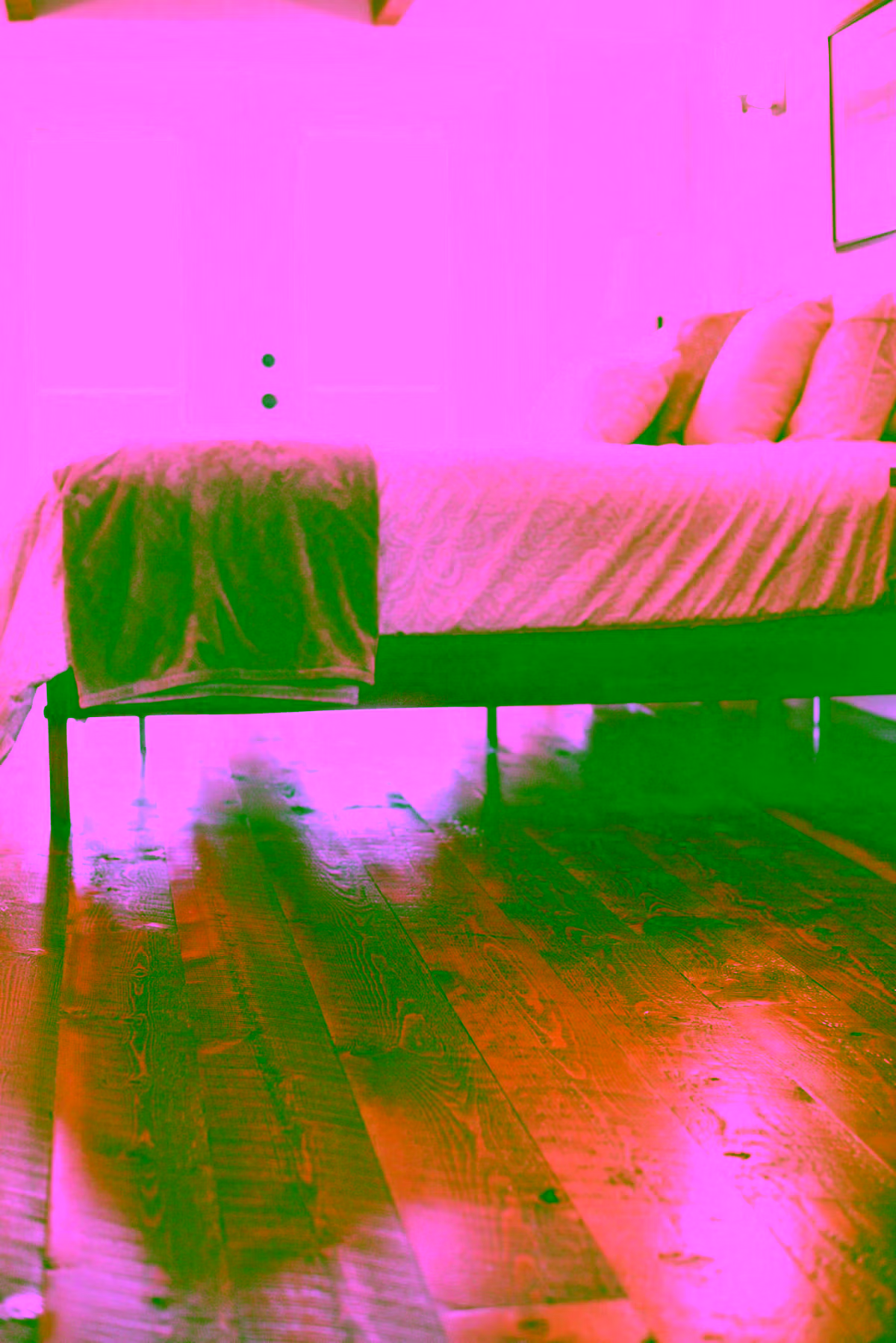 Low-angle view of rich warm dark hardwood floors in a bedroom