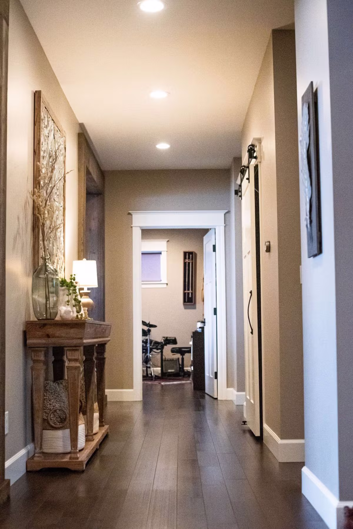 Long hallway with dark espresso hardwood floors